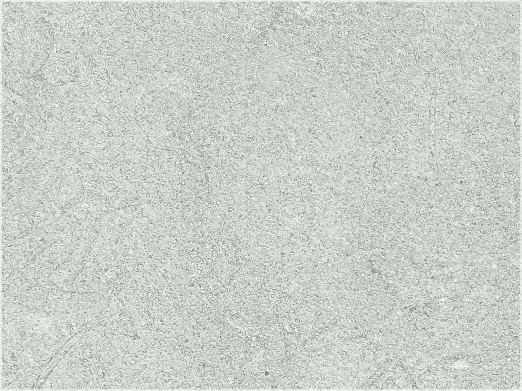 Close-up of Rustic Green marble with a pale green-gray surface and fine mottled texture.