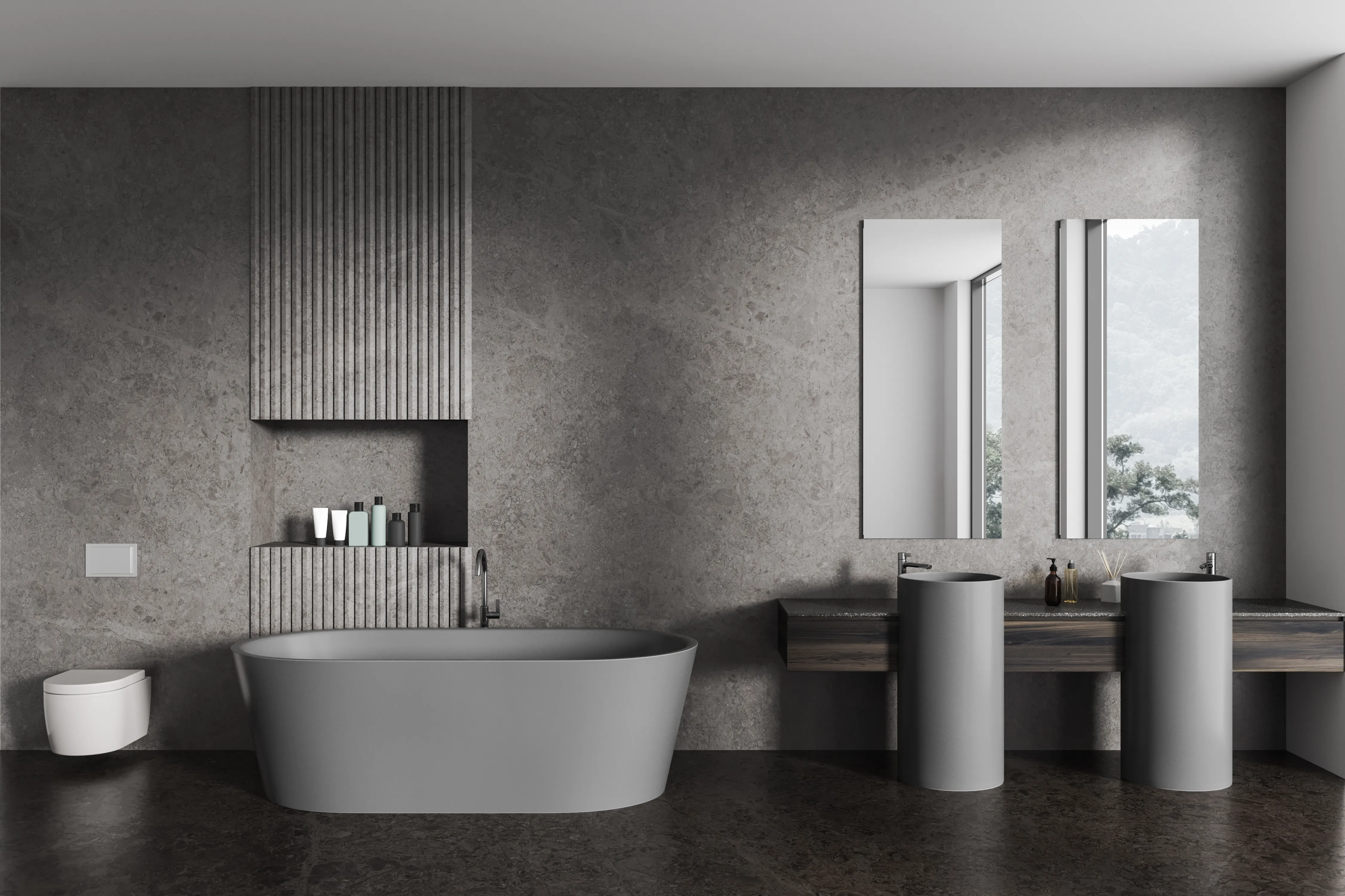 Gray bathroom with textured walls, a freestanding bathtub, twin cylindrical pedestal sinks, and tall rectangular mirrors.
