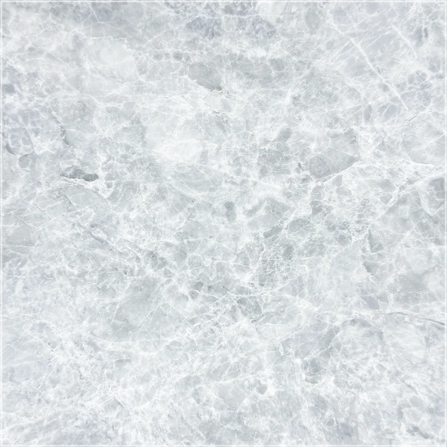 Tundra Grey marble with a polished finish and intersecting white veins across a light gray background.