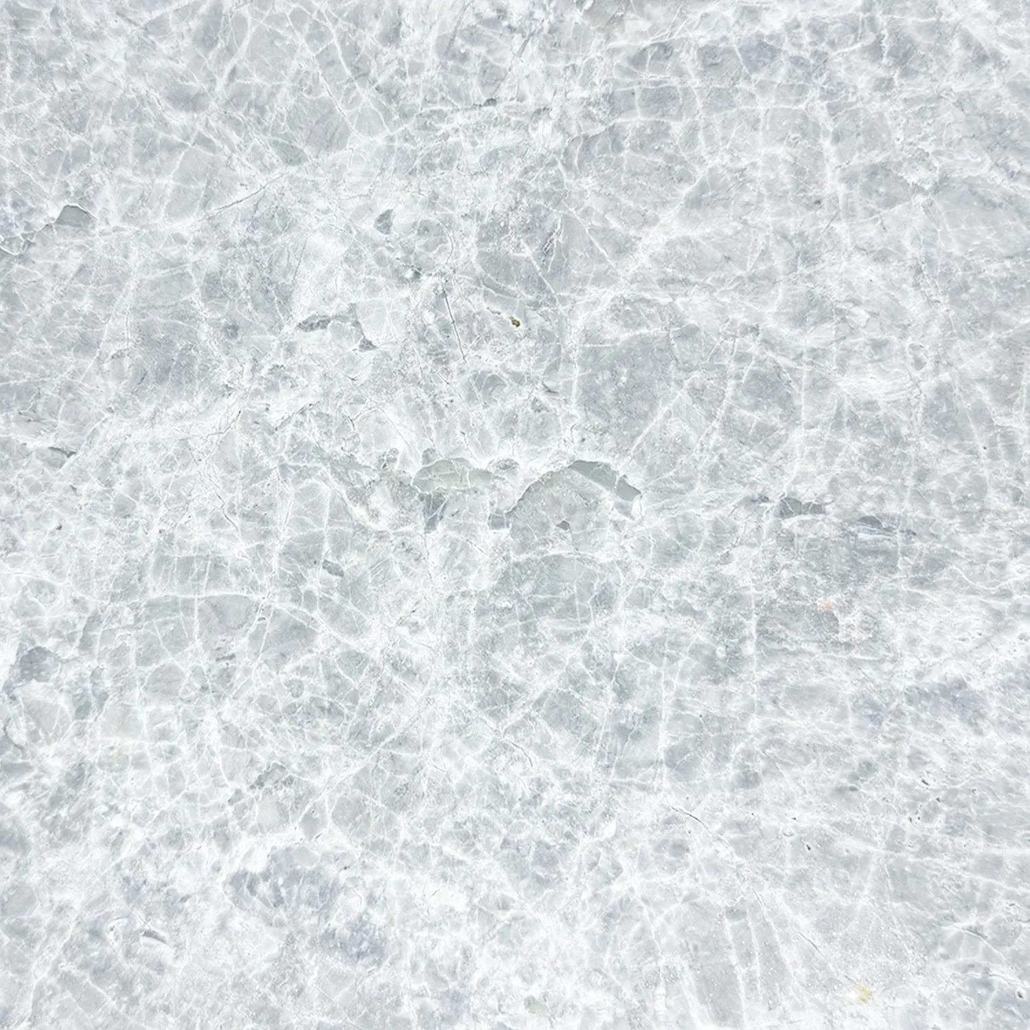 Tundra Grey marble with a brushed finish, textured gray and white veining, and scattered darker gray patches.