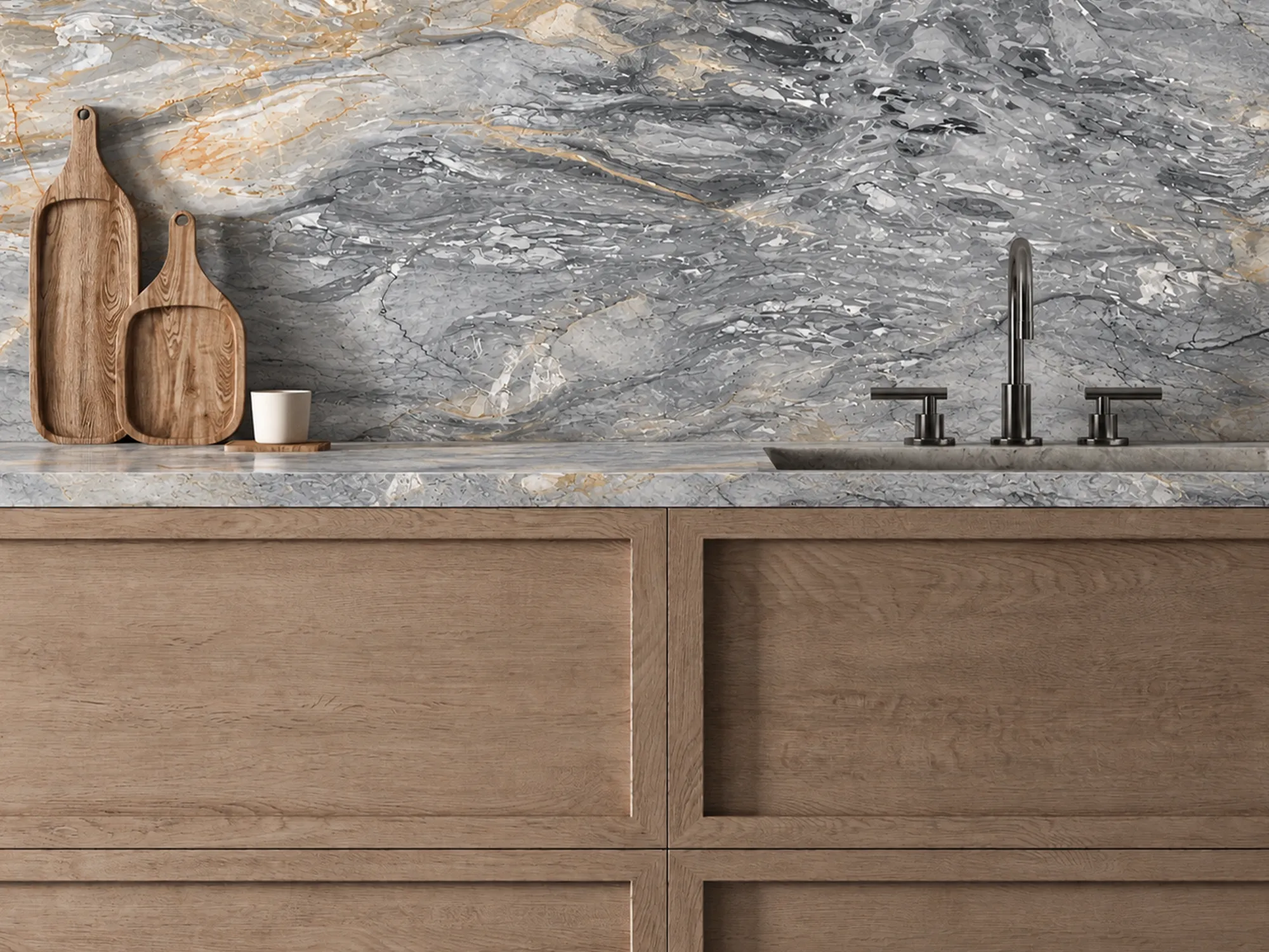 Belvedere Grey marble kitchen countertop and backsplash with layered gray and gold veining, wood cabinets, and a dark metal faucet.