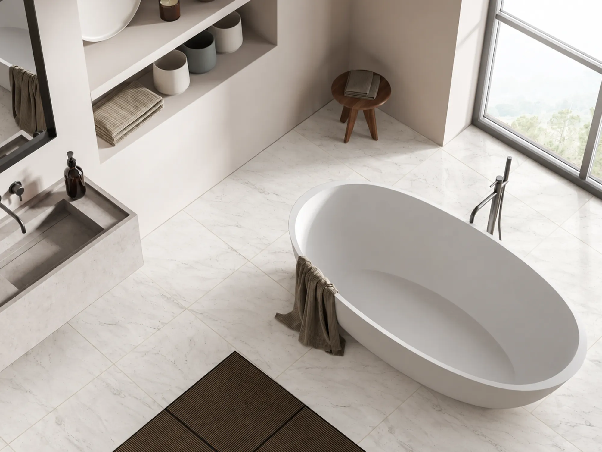 Calacatta Cremo marble flooring with subtle gray veining around a freestanding white bathtub in a bright bathroom.