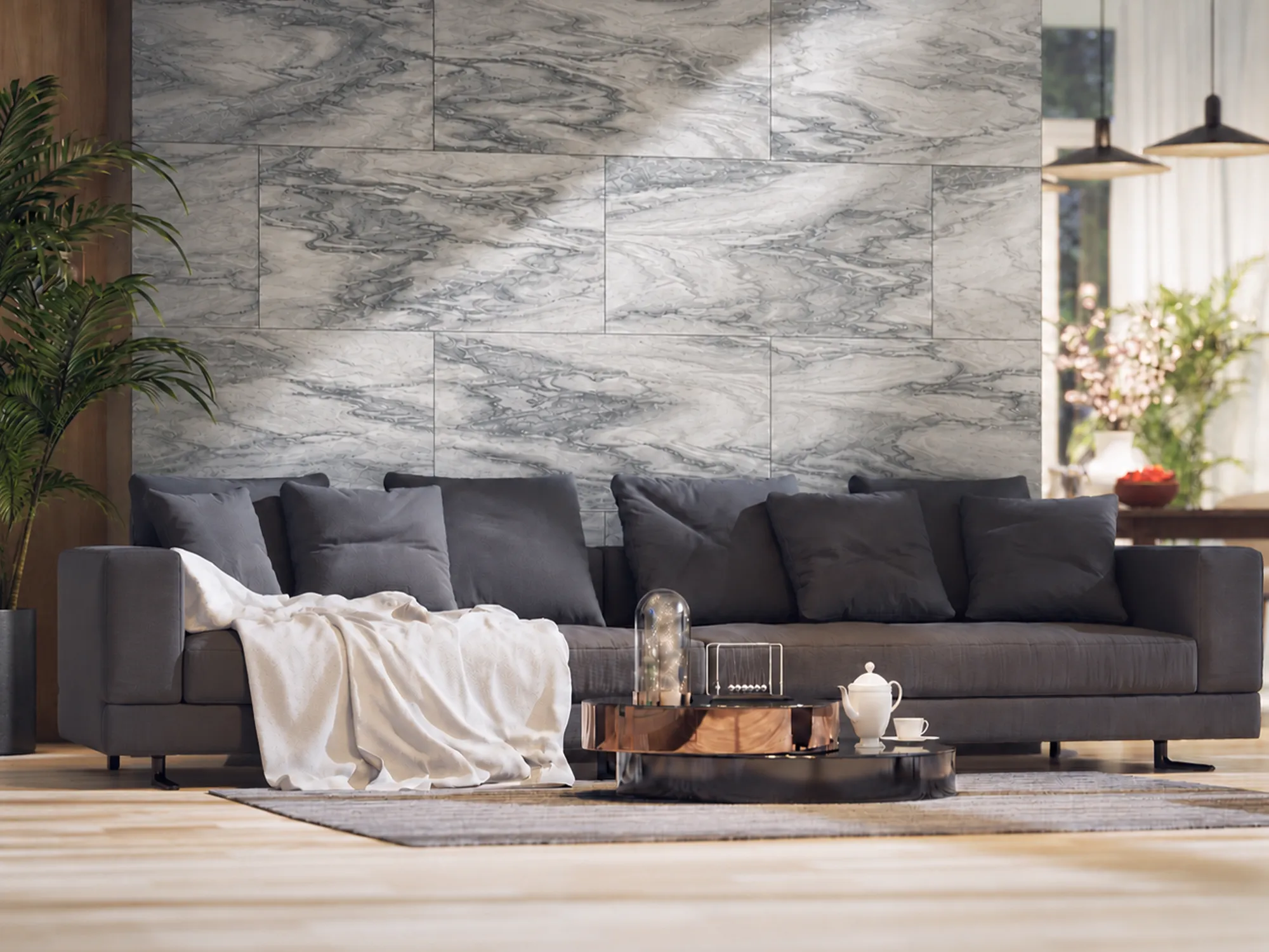 Cipollino Verde marble feature wall with flowing gray and white veins behind a dark gray sofa in a bright living room.
