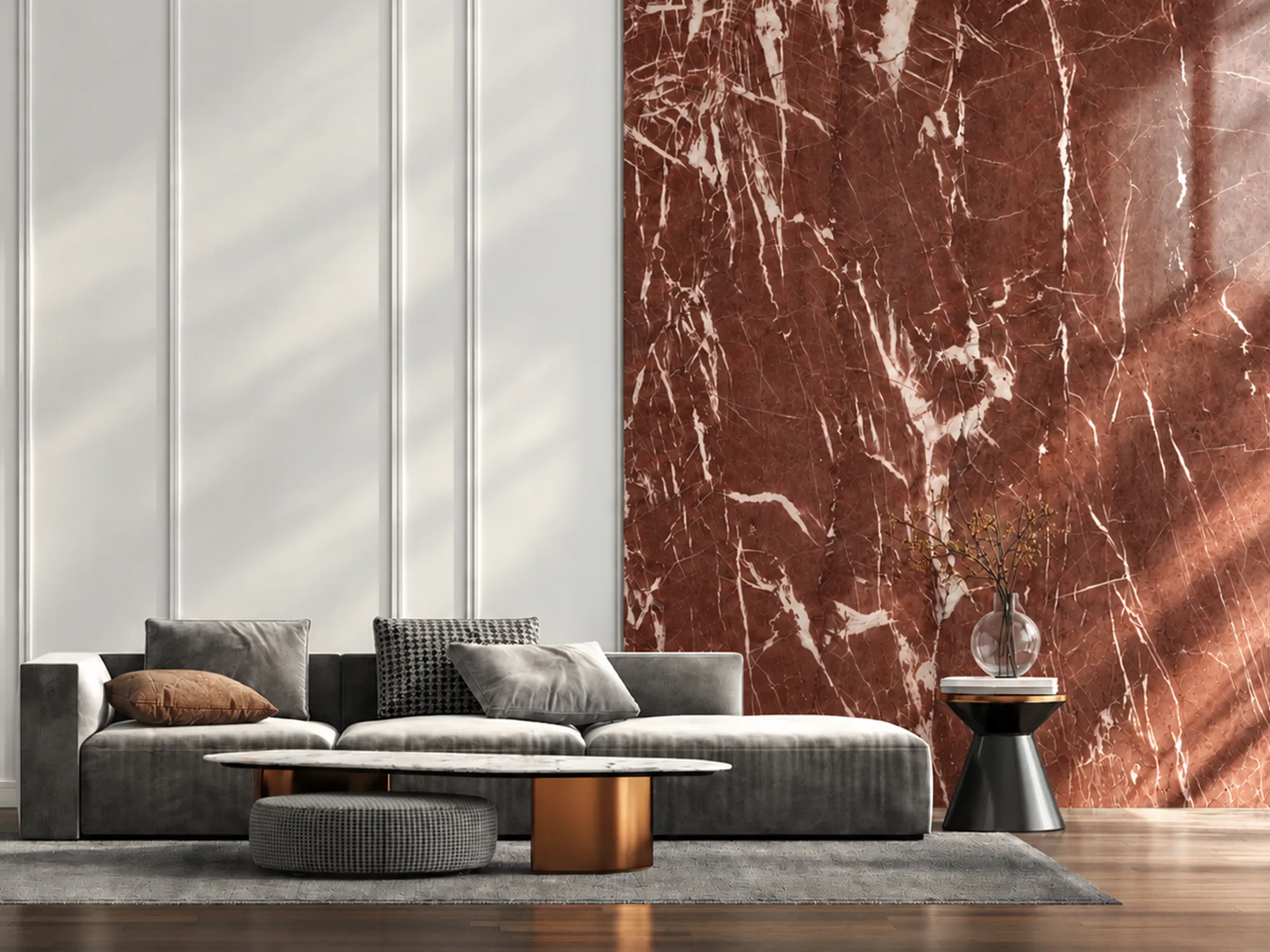 Rosso Antico red marble feature wall with white veining beside white wall panels and a gray sofa in a sunlit living room.