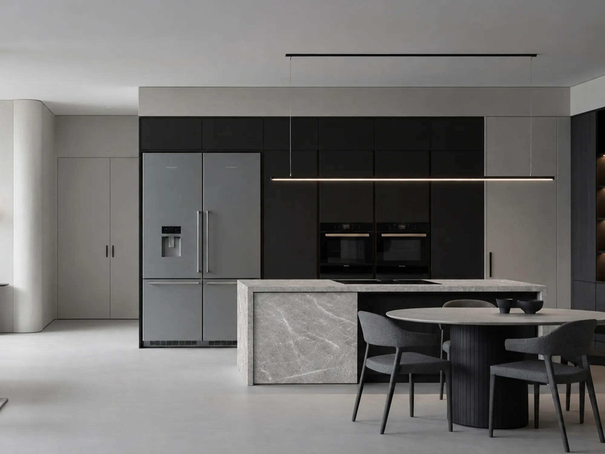 Tundra Grey Light marble kitchen island with white veining across its countertop and vertical panels beside dark cabinetry.