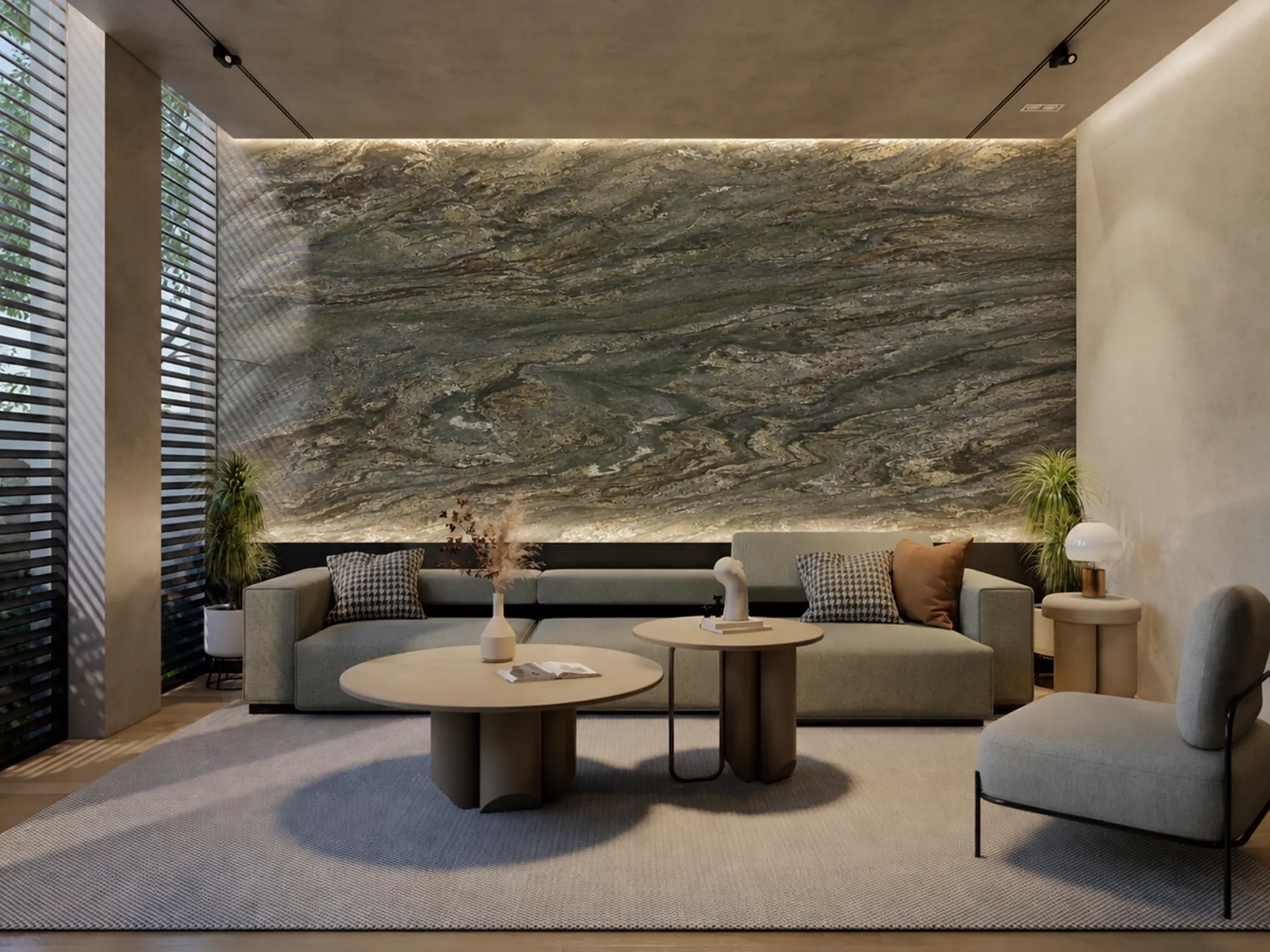 Verde Oasis green marble feature wall with rippling gray and cream patterns behind a gray sofa, lit along its upper and lower edges.