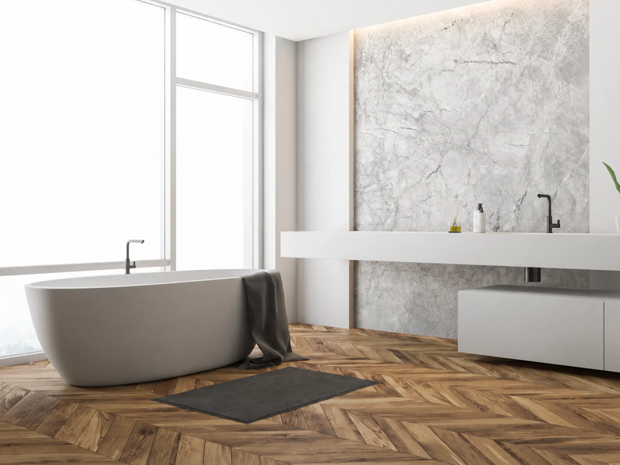 Invisible Grey marble feature wall behind a floating white bathroom vanity beside a freestanding bathtub and wood floor.