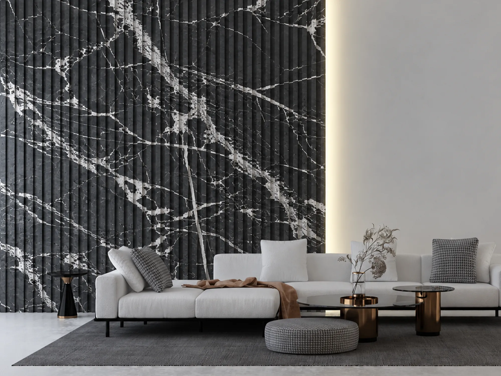 Vertically fluted Taurus Black marble feature wall with bold white veining behind a white sofa and dark coffee tables.