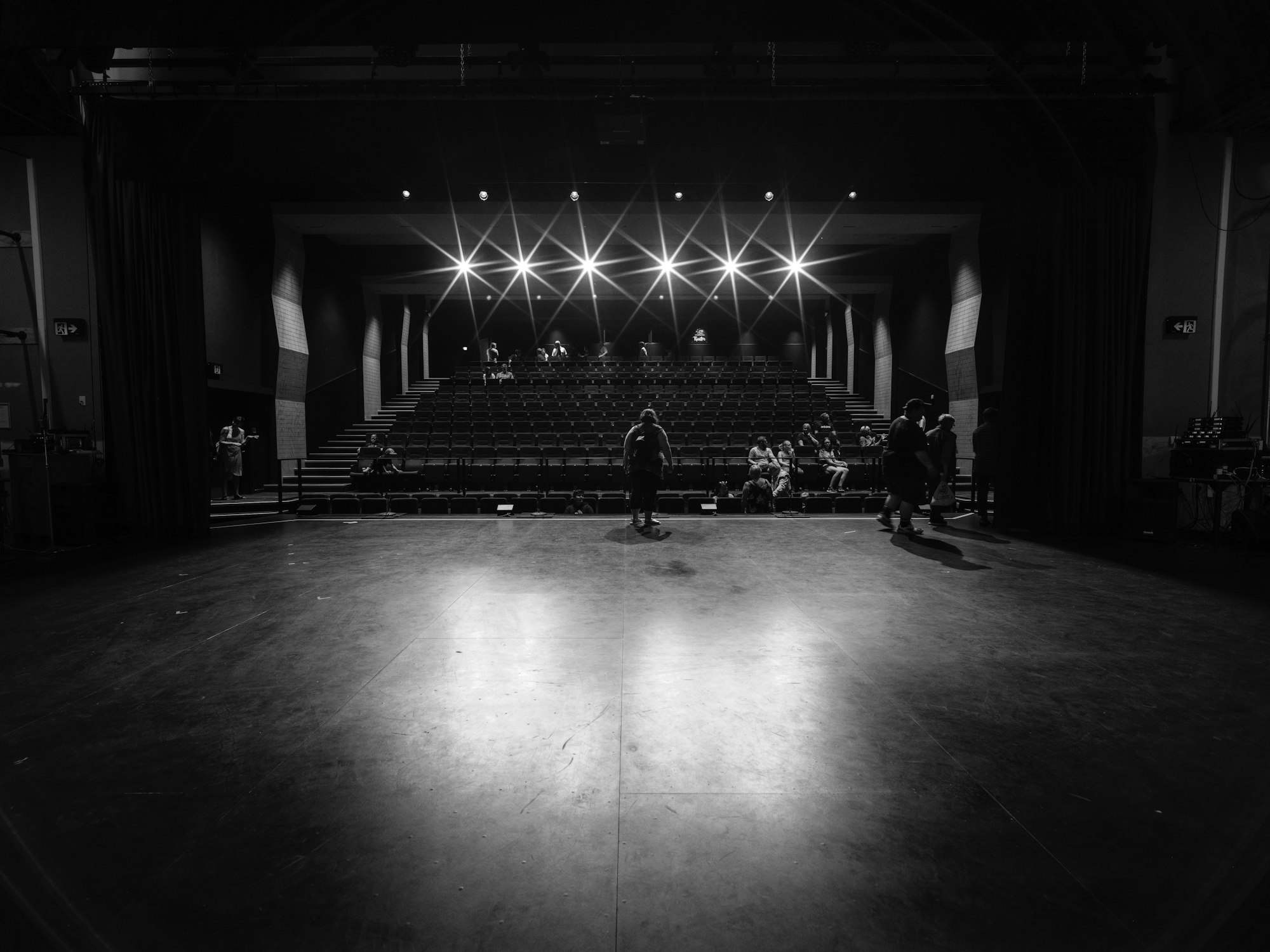 Empty theatre with stage lights and rows of seats