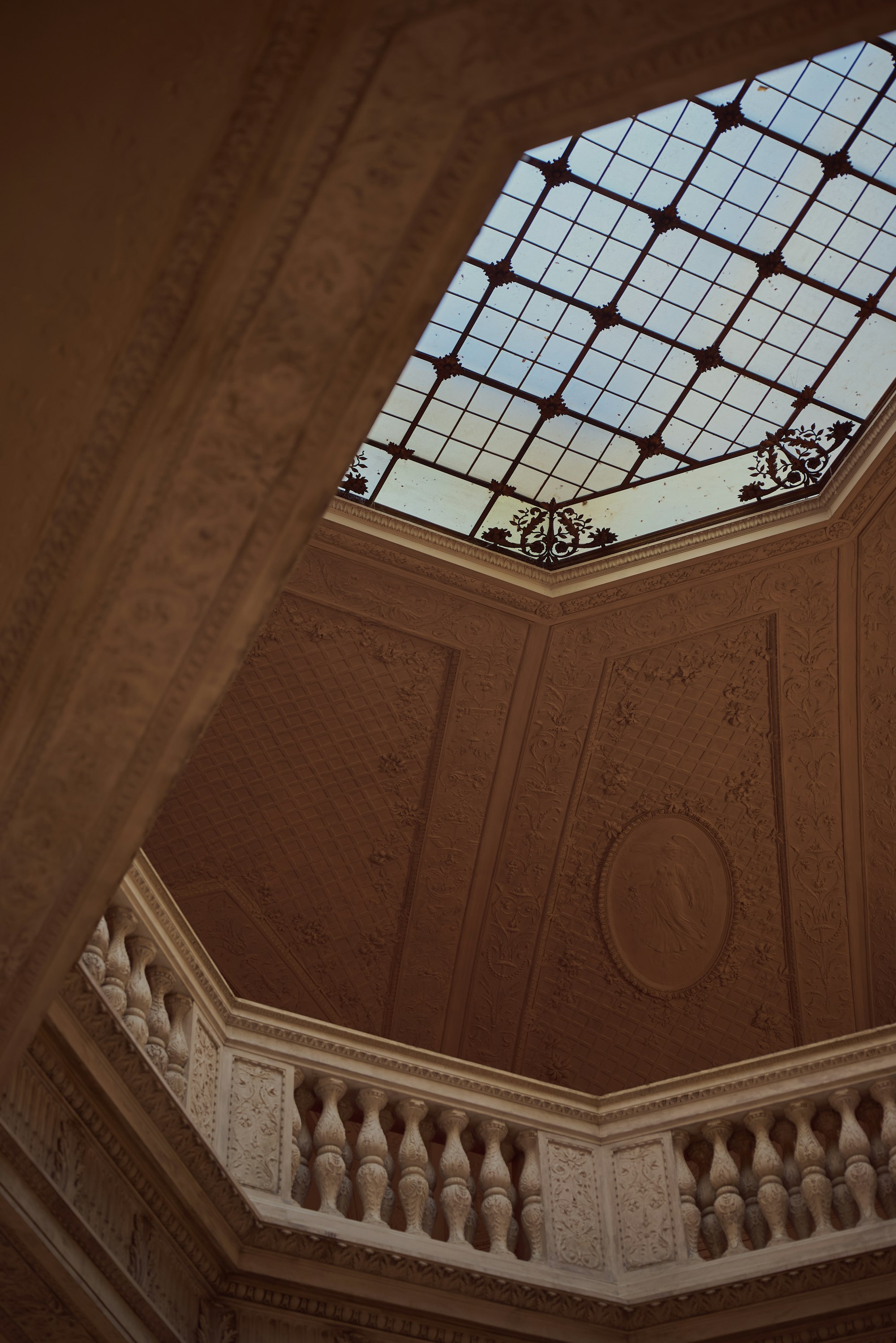 Ornate ceiling with a glazed skylight in a historic building