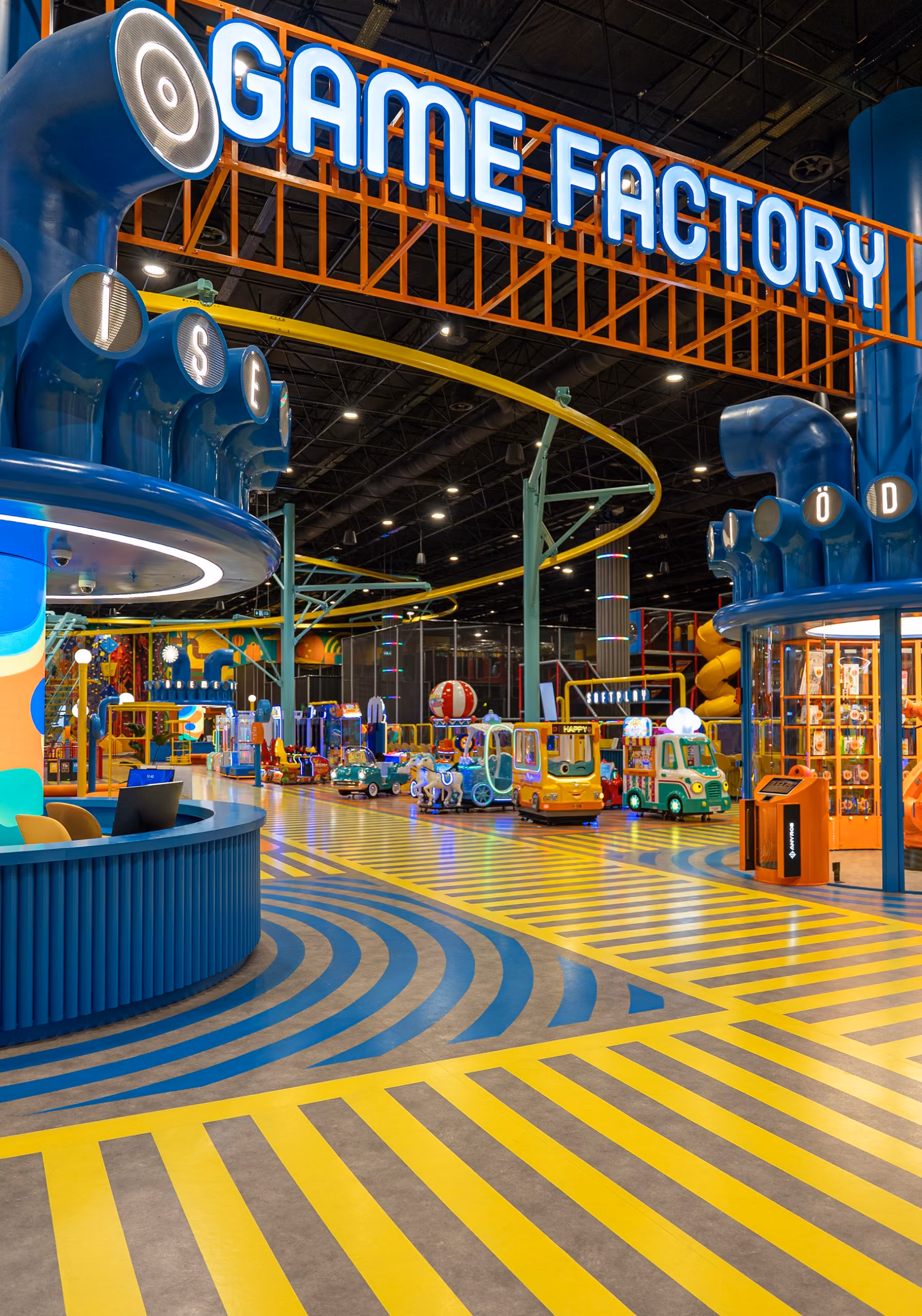 Game Factory entertainment venue by Feltouch, showing multiple gaming zones under a high ceiling