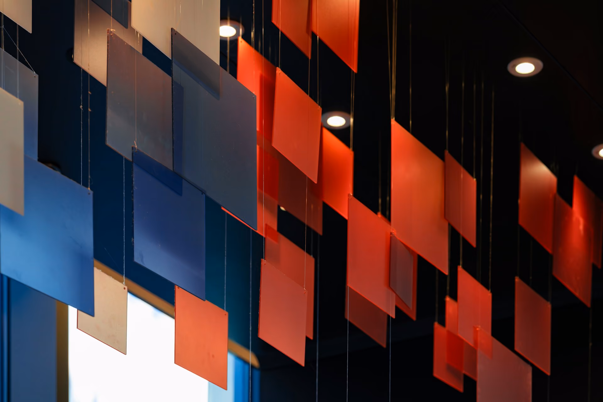 Colourful acoustic ceiling baffles hanging in a modern interior