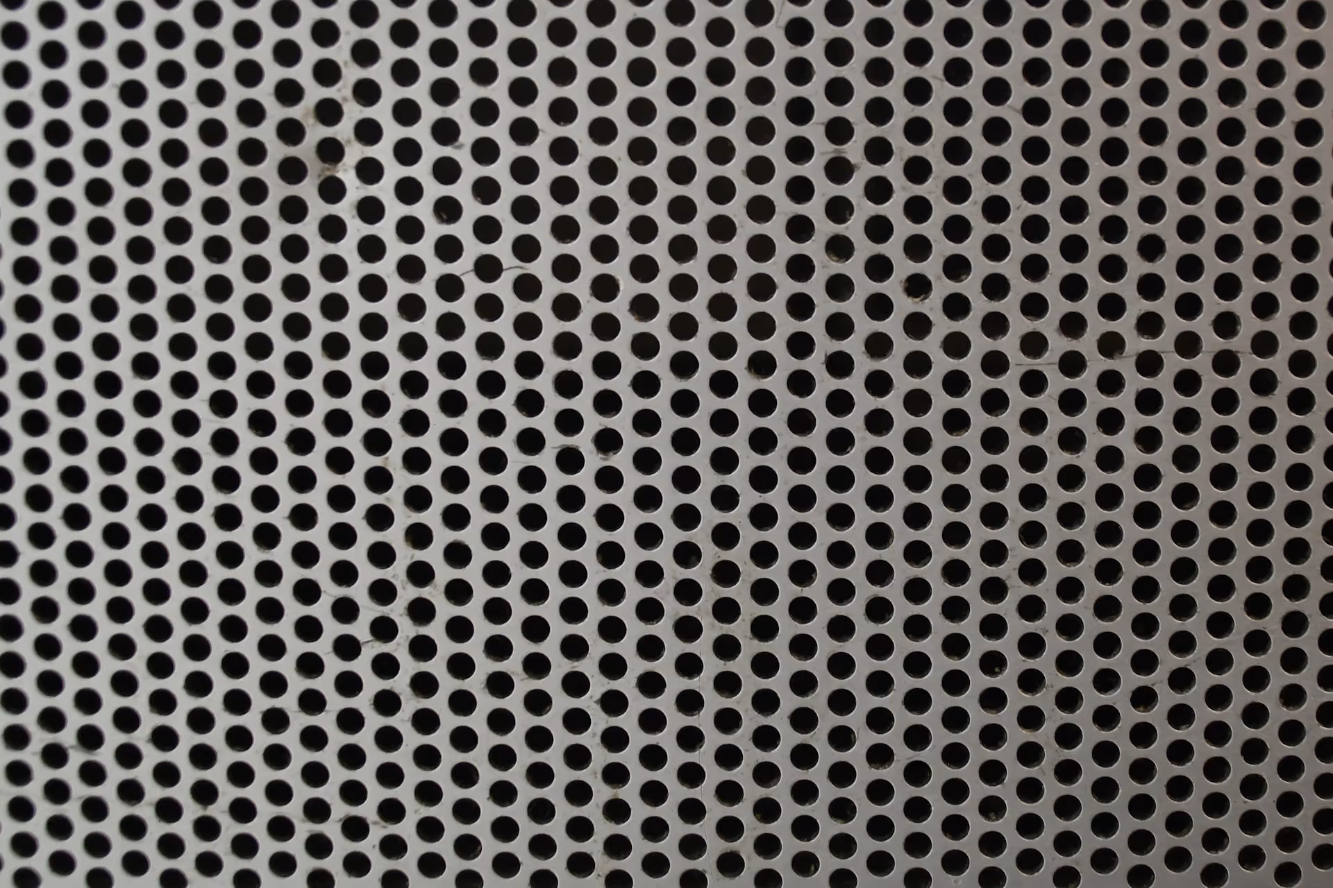 Fine microperforated metal acoustic panel with a regular hole pattern
