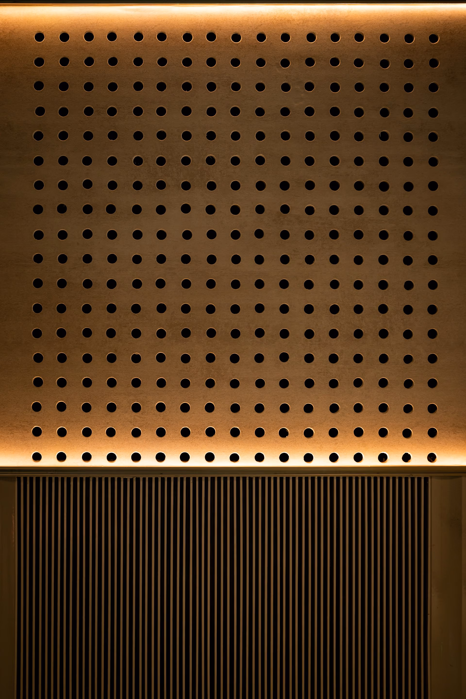Perforated acoustic wood wall panel with warm strip lighting