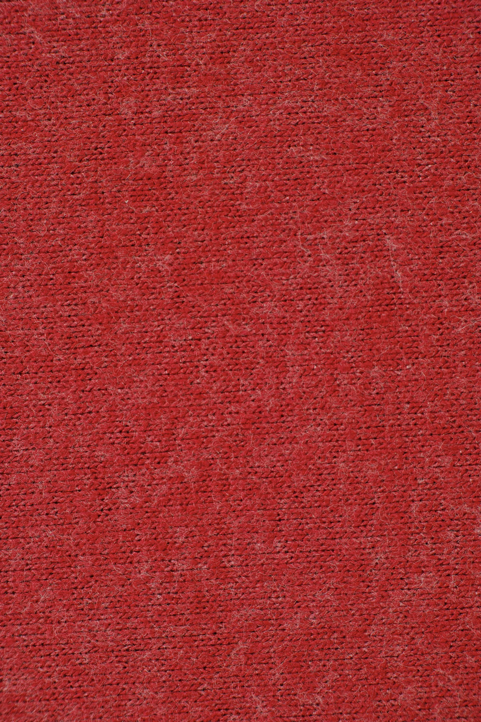 Close-up of red felt acoustic panel fabric texture
