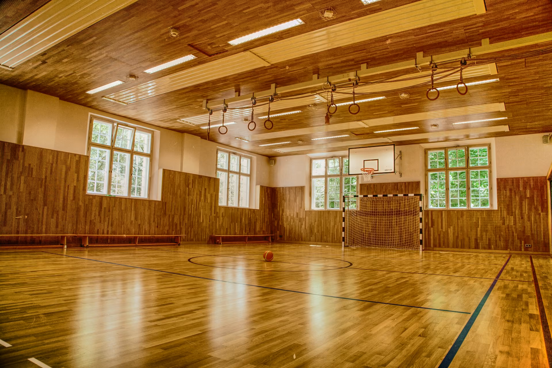 School sports hall with timber floor, wall bars and high windows