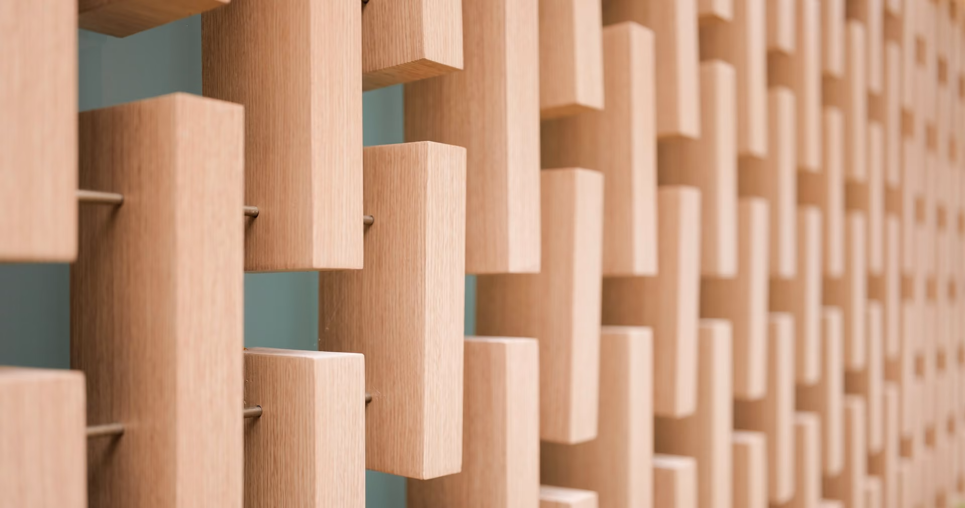 Timber block diffuser on a wall scattering sound across the room