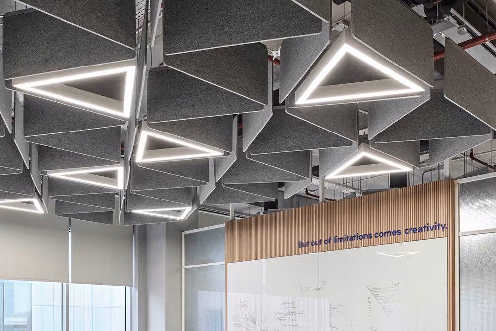 Vertical acoustic ceiling baffles suspended in rows across a ceiling