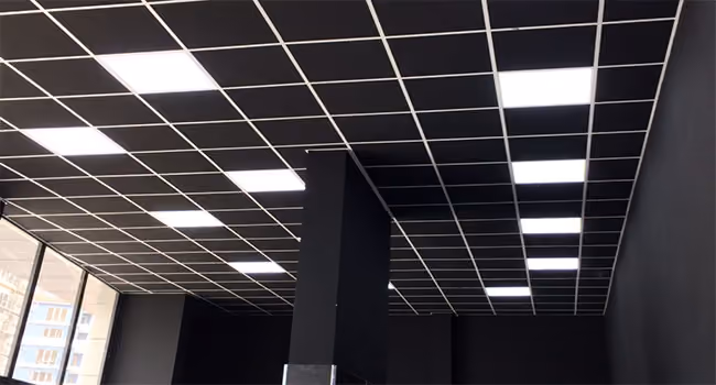 Modular acoustic ceiling tiles fitted into a suspended grid system
