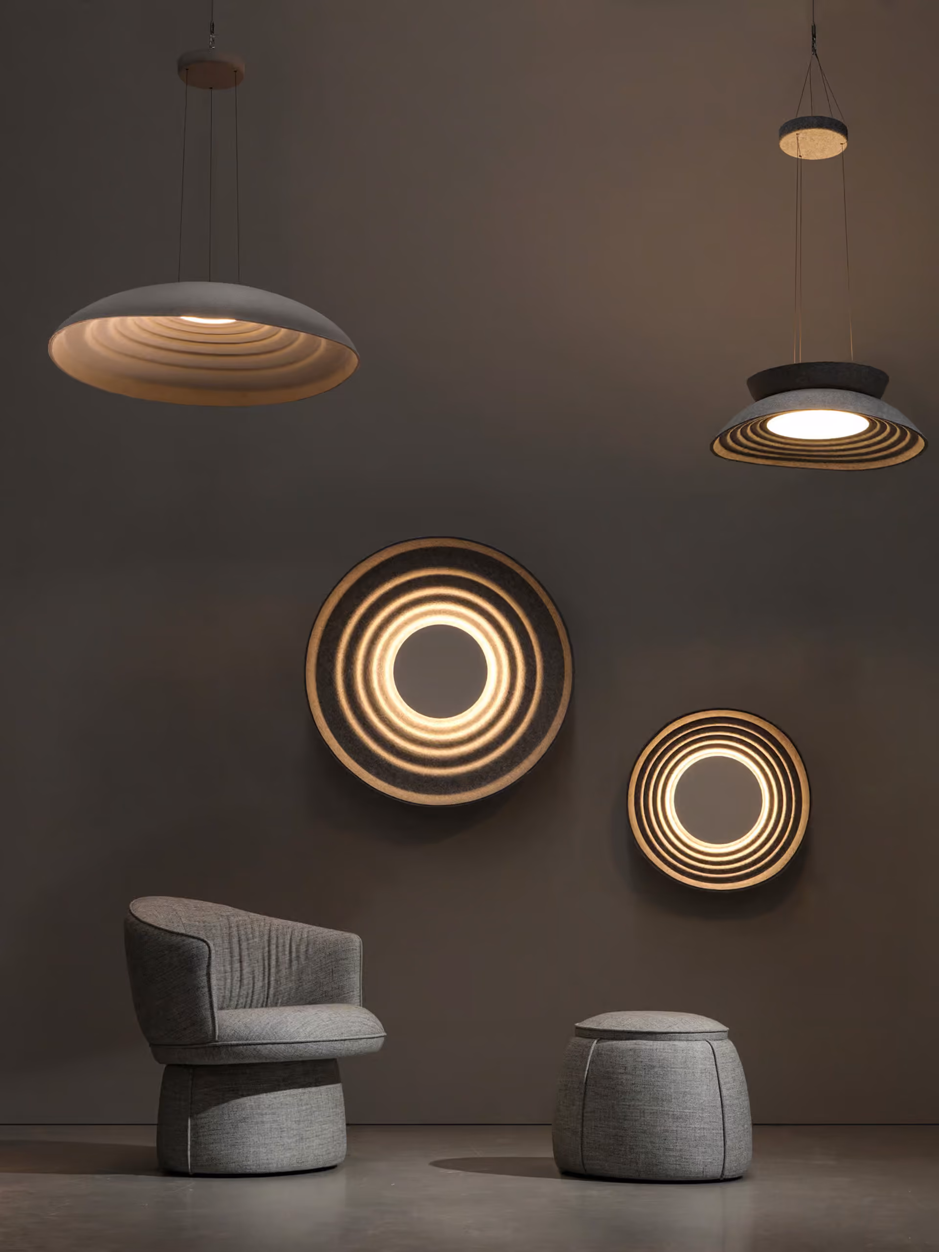 Bowl-shaped acoustic light fitting suspended above a seating area