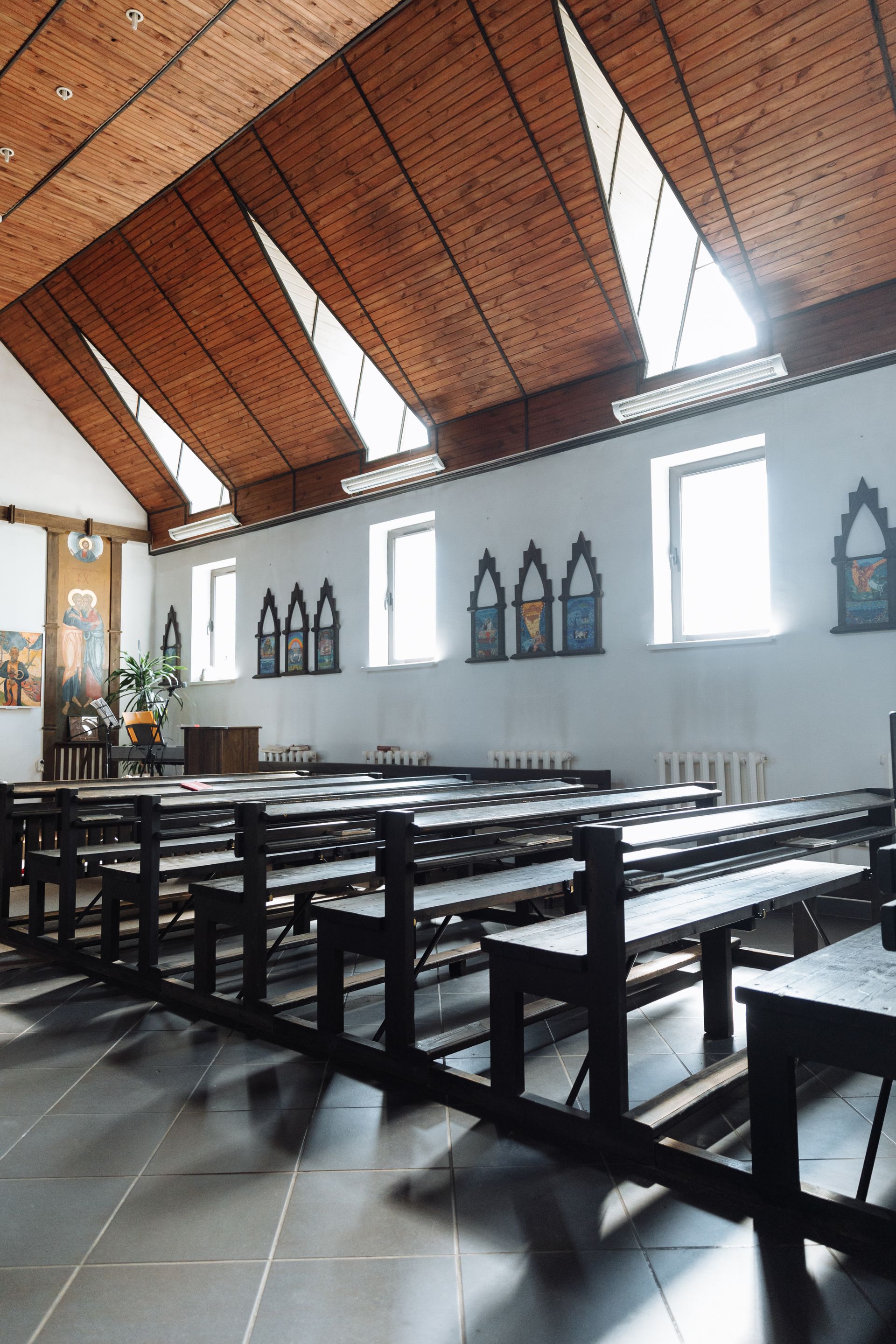 Community church hall with a timber-lined pitched ceiling and wooden benches