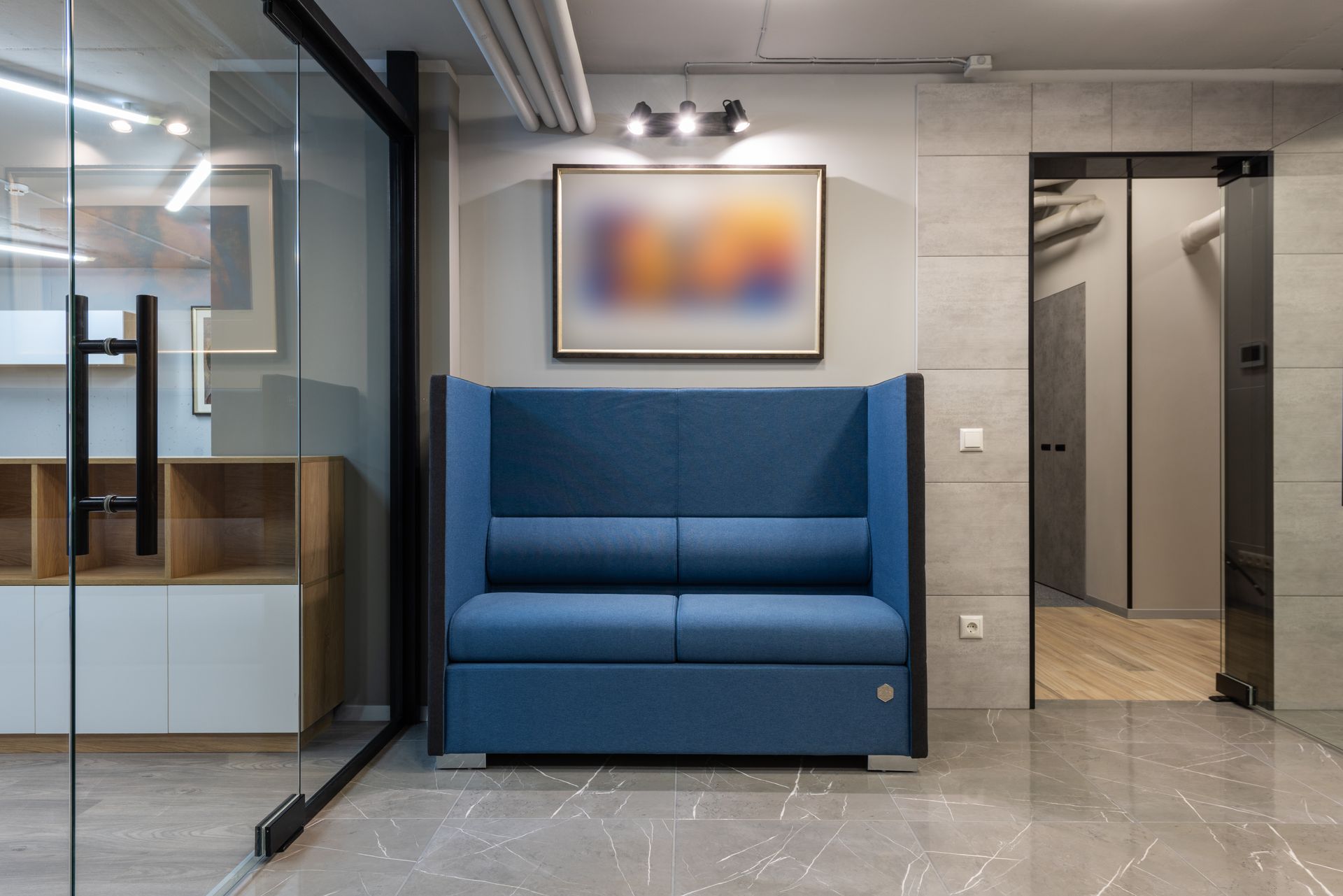 High-back upholstered acoustic sofa in a calm office lobby