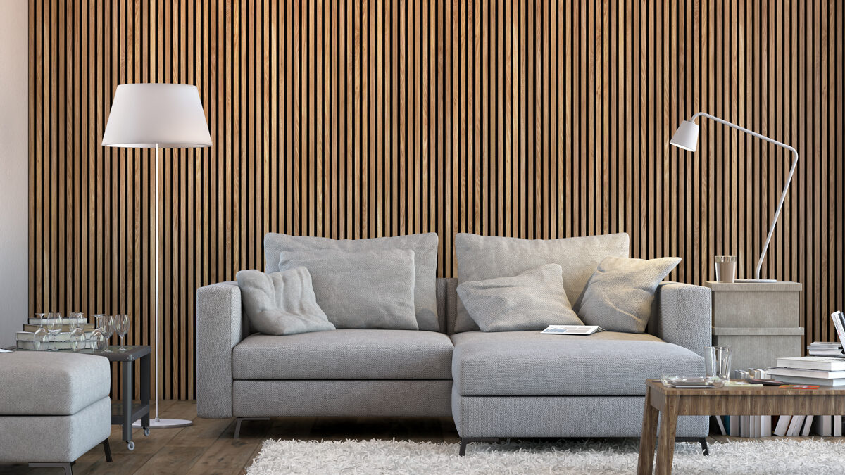 Vertical timber slat acoustic panels on felt backing behind a living room sofa