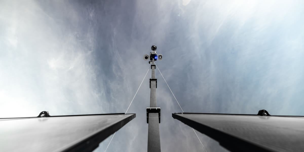 Looking up the mast between the two solar panels to the camera head.