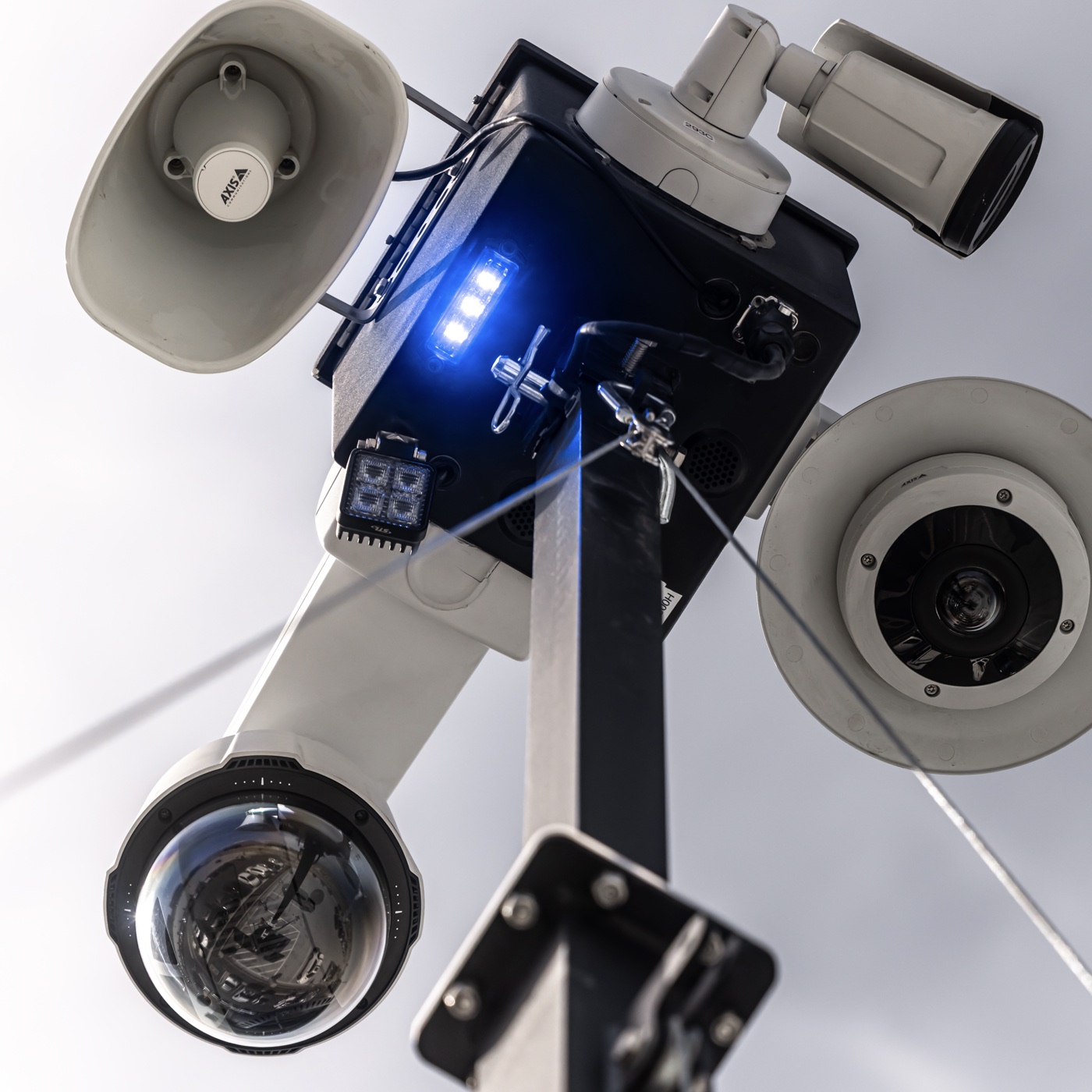 The unit's two loudspeaker horns and blue strobe, seen close up from below.