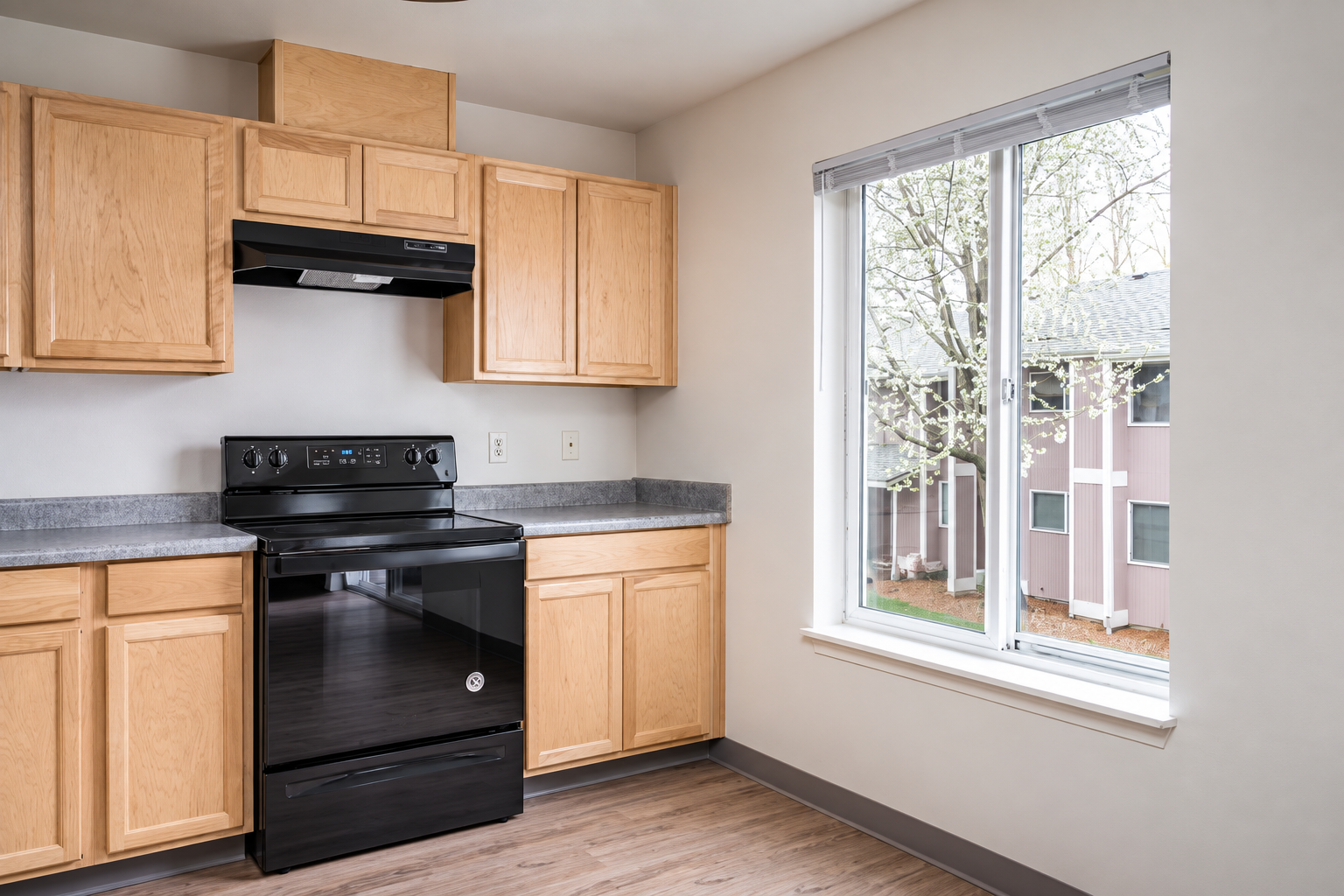Kitchen with brown cabinets and black appliances