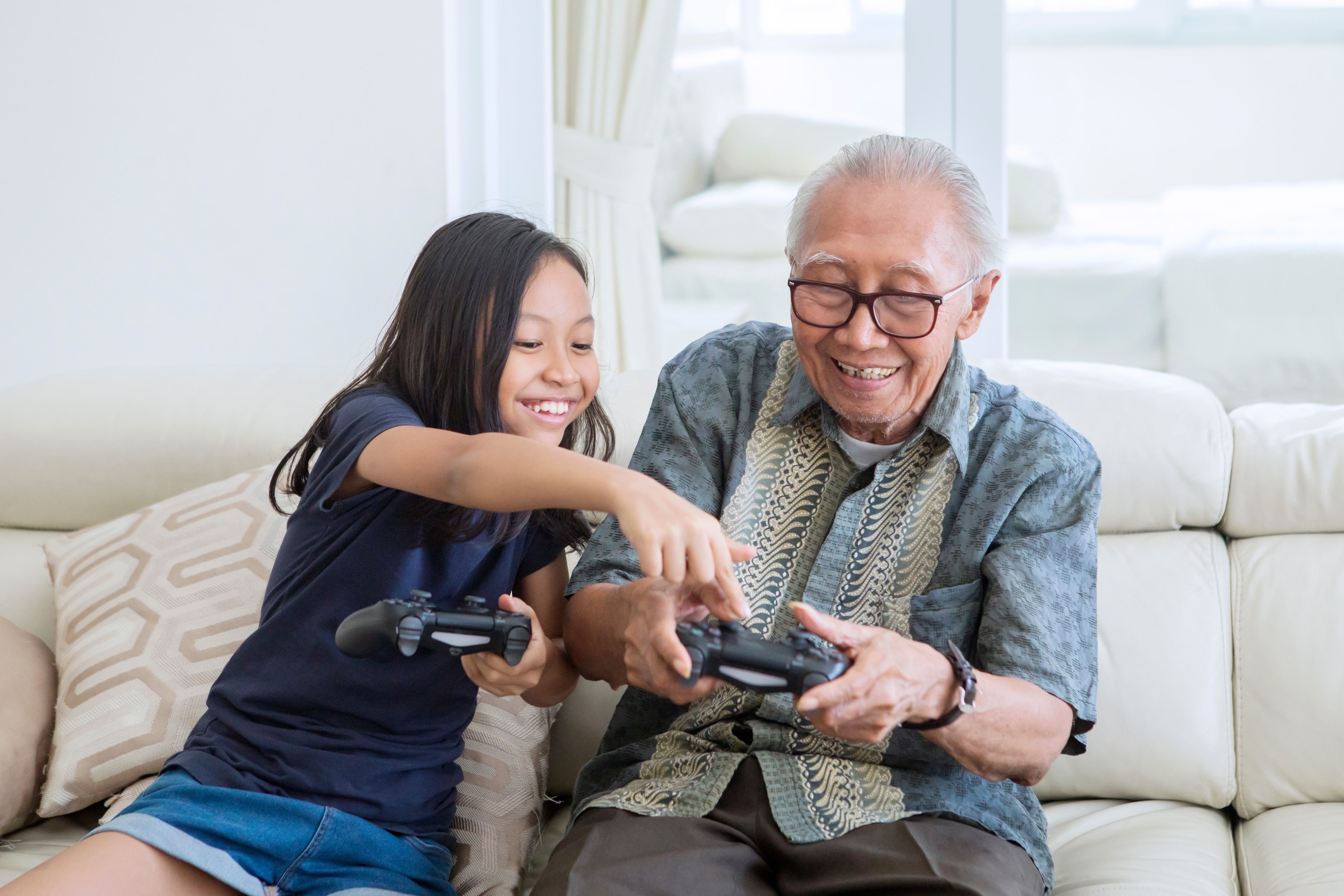Man and young girl playing video games stock image