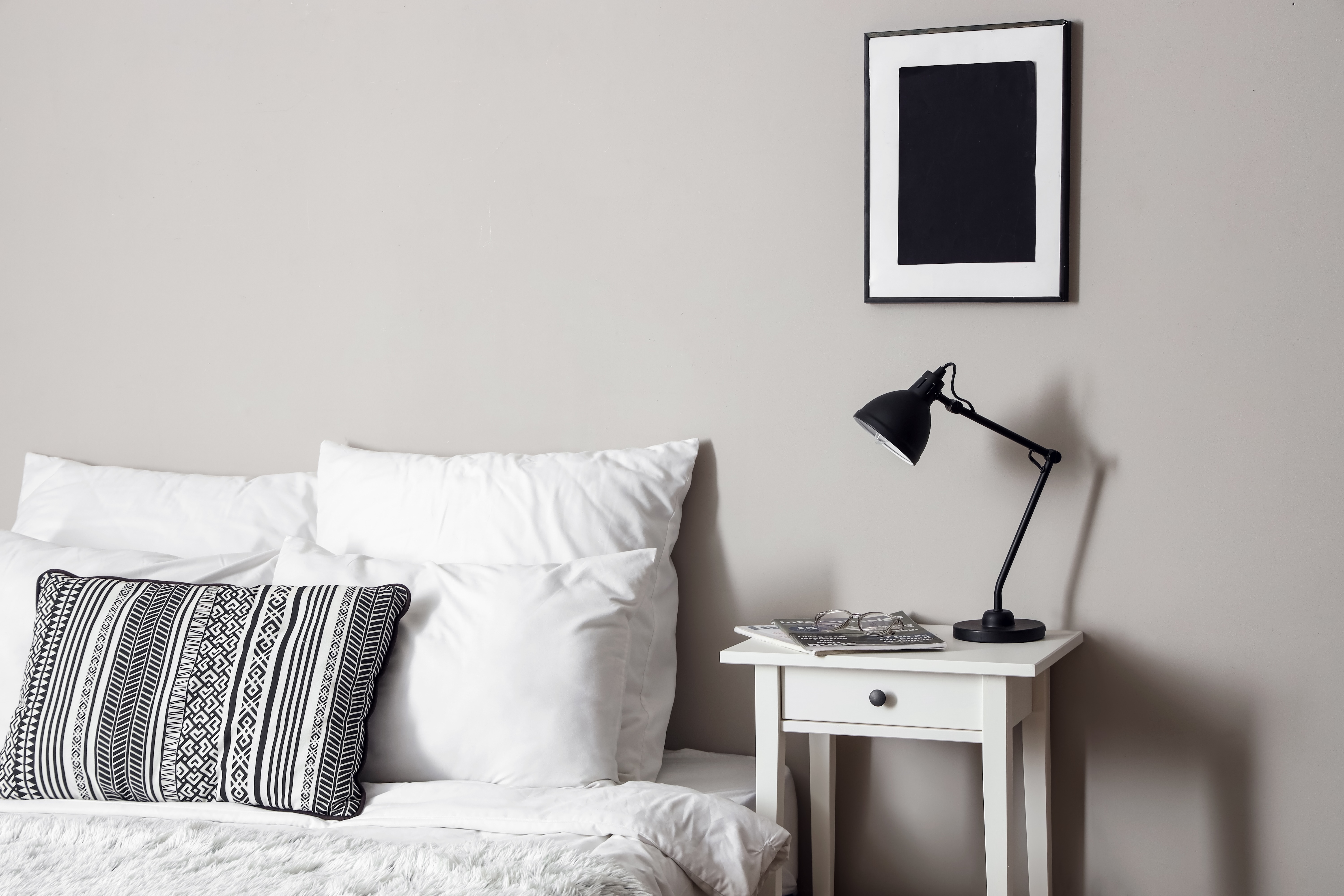 Bed with table next to it stock image