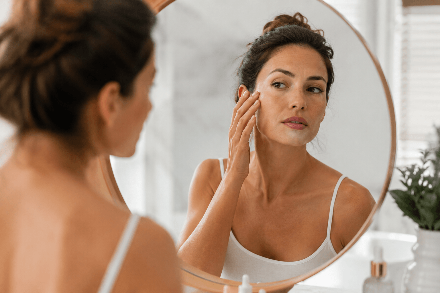 Woman learning about collagen loss after age 30 and skin rejuvenation options at an aesthetic clinic in Park Cities, Dallas, Texas.