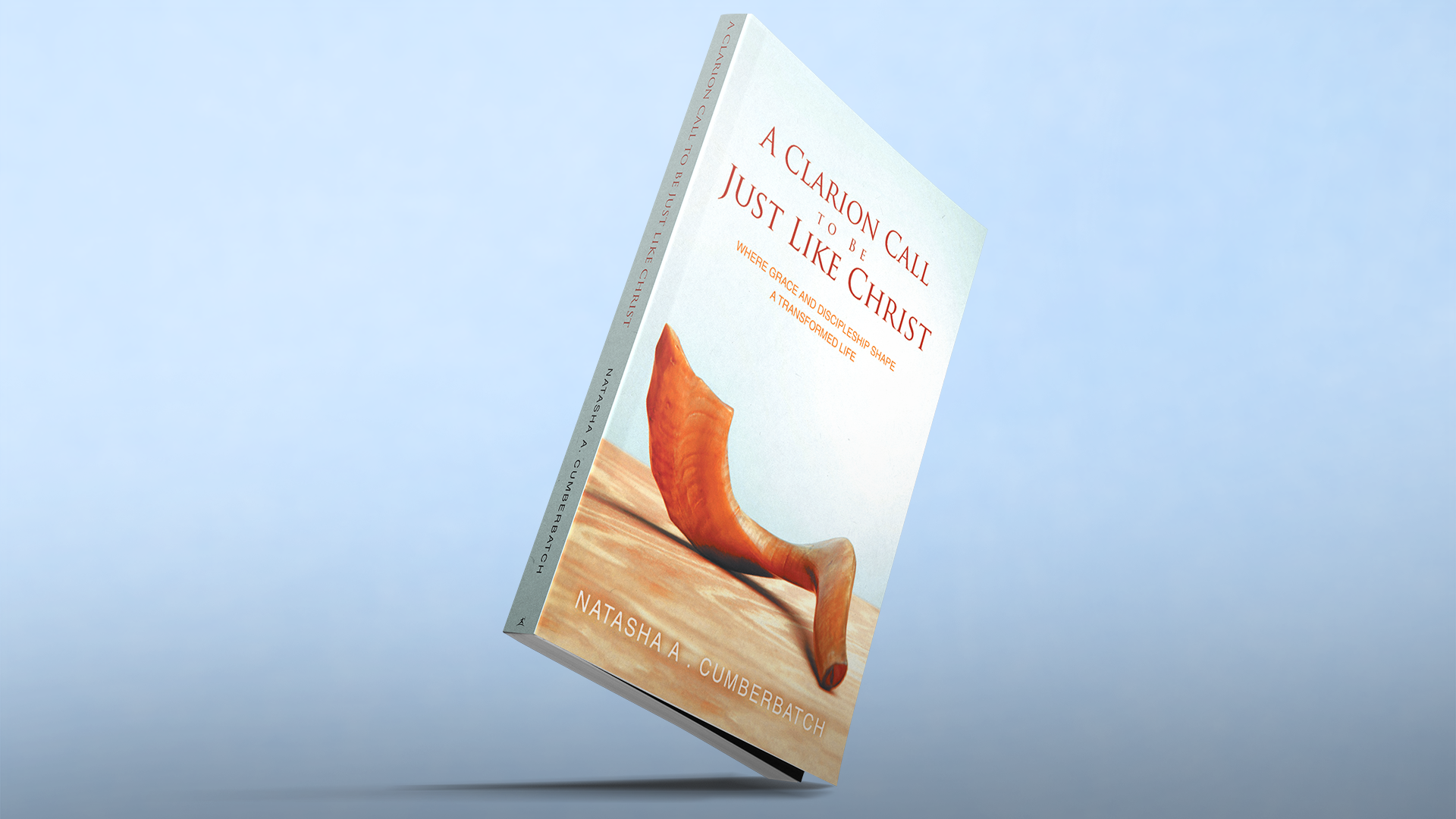 A Clarion Call to Be Just Like Christ book balanced on its corner against a pale blue background