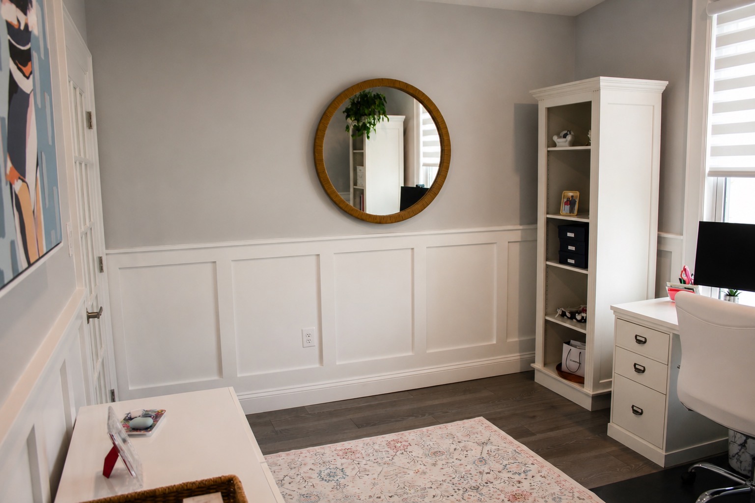 Home office with board and batten wainscoting and round mirror
