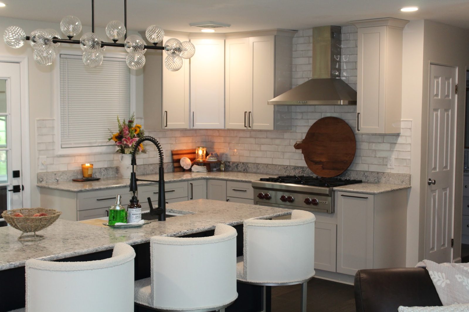Finished Hylen kitchen with island, chandelier, and white cabinets