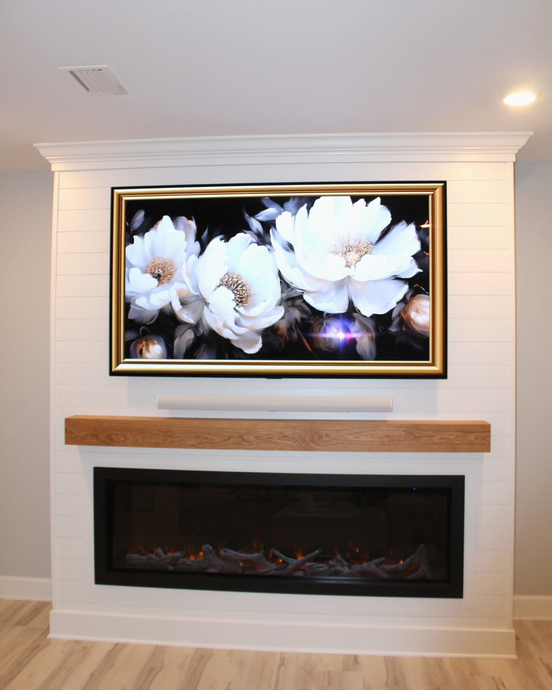 Shiplap built-in with electric fireplace and wood mantel
