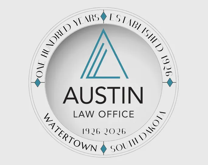 Circular logo for Austin Law Office featuring a teal stylized letter A above the text 'AUSTIN LAW OFFICE 1926-2026,' with outer ring text reading 'ONE HUNDRED YEARS ESTABLISHED 1926 WATERTOWN SOUTH DAKOTA' separated by small teal diamond shapes.