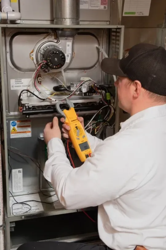 A technician working on a furnace