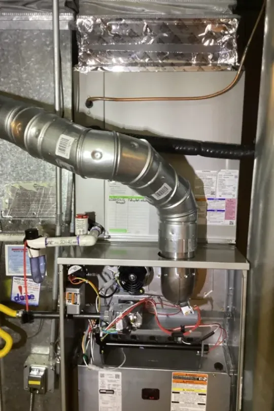A furnace with an open panel.