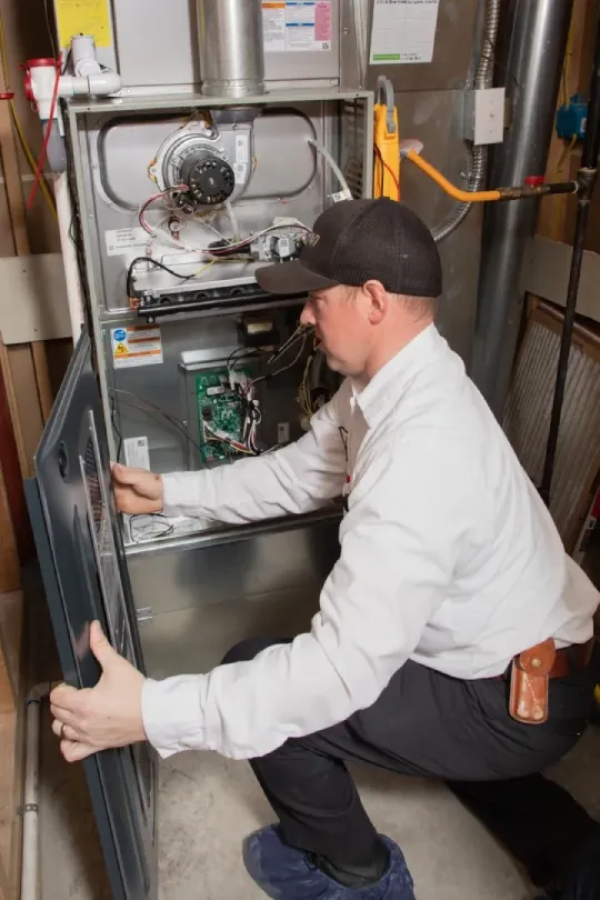 A technician working on a furnace