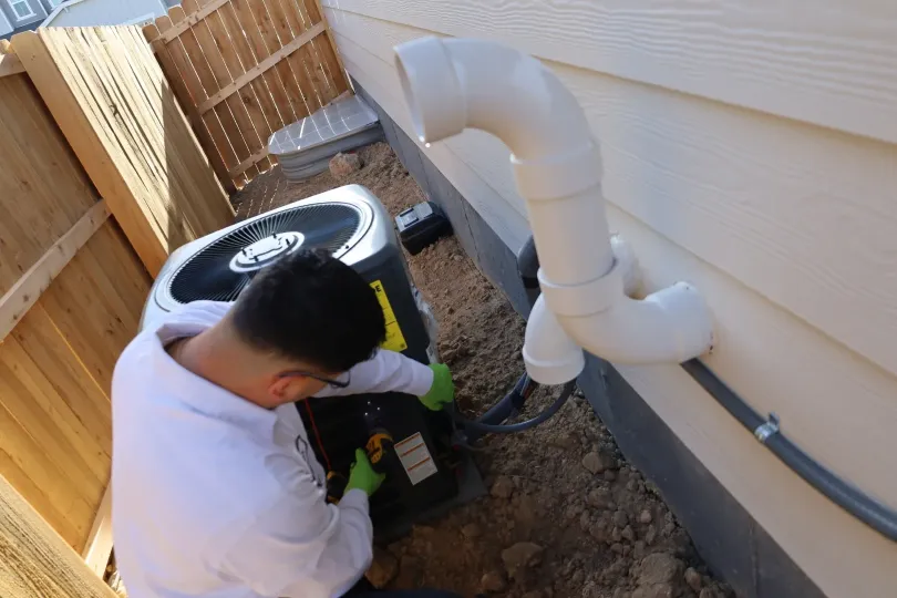 A technician working on installing an AC unit.