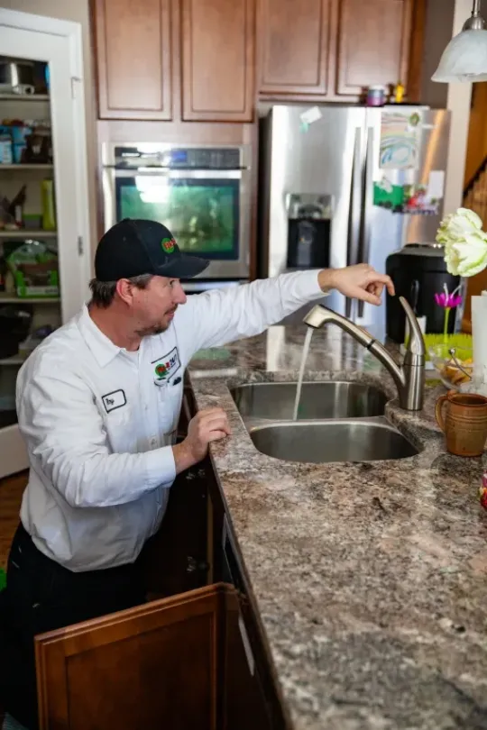 A technician working on a customer's sink.