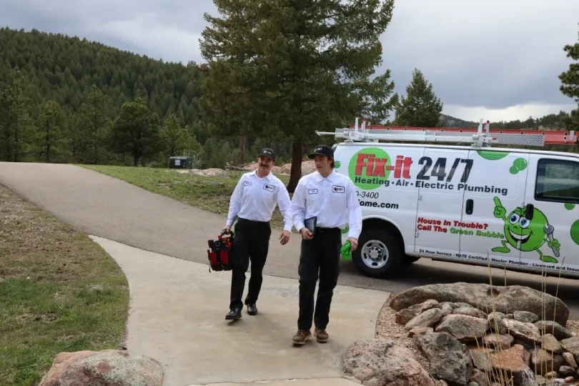 Two technicians walking up to a customer's house.
