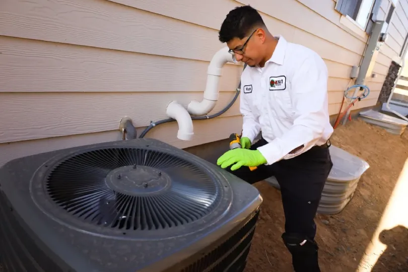 A technician working on an AC unit.