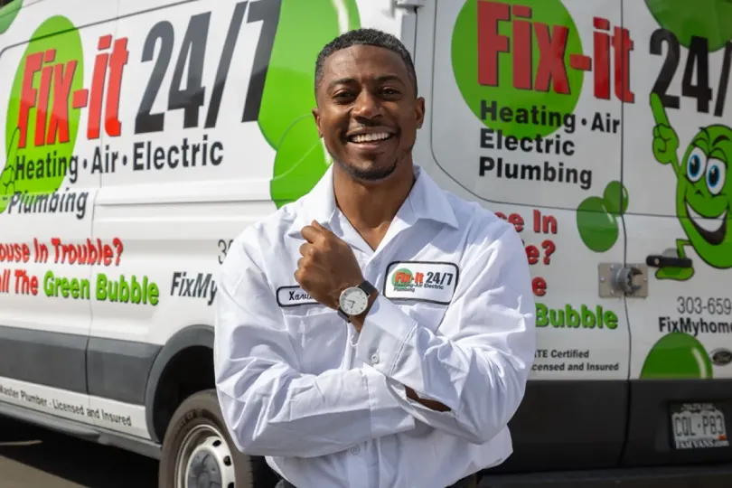 A technician standing next to a Fix-it van