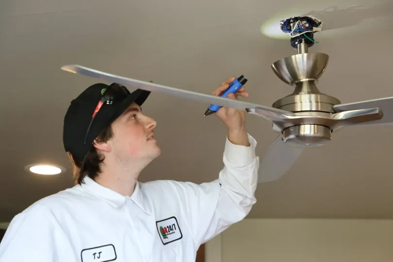A technician working on a fan.