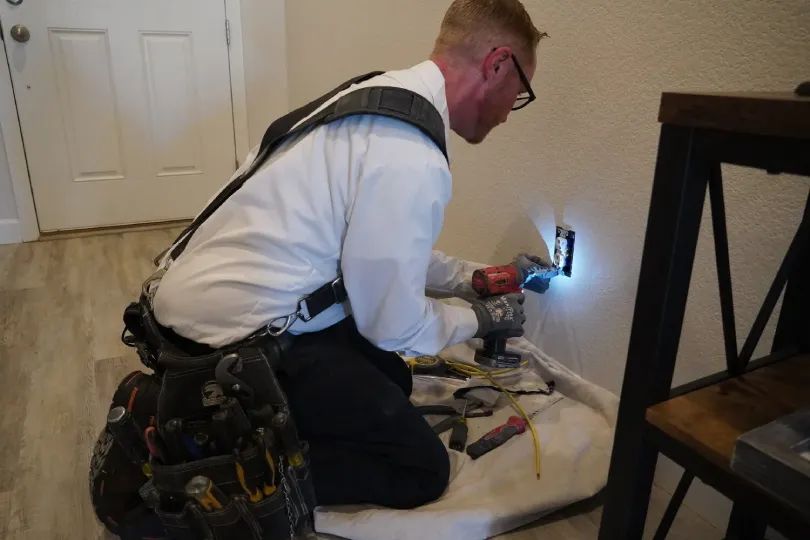 A technician working on electrical wiring