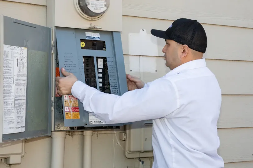 A technician working on an electrical panel.