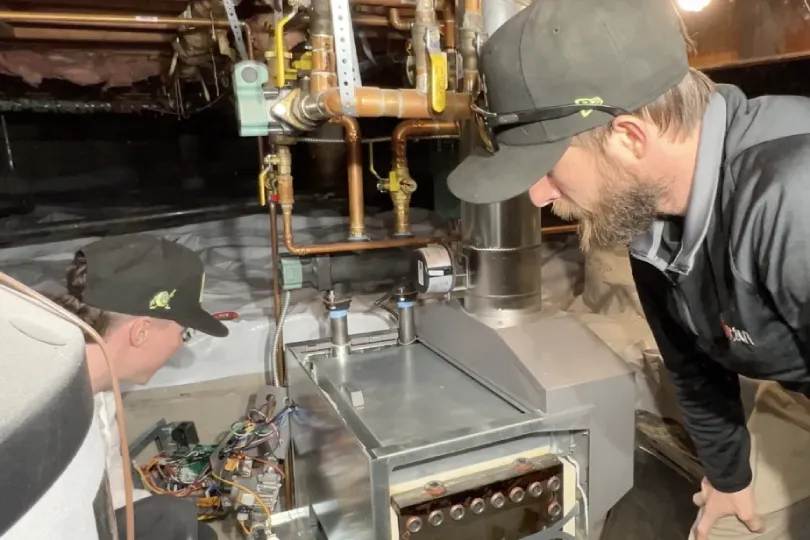 A technician working on a boiler.